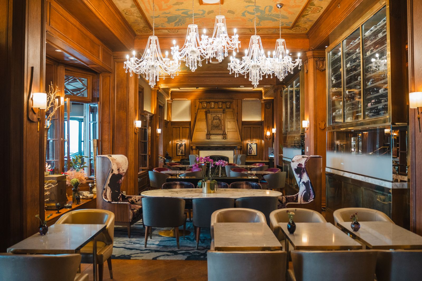 Multiple chandeliers illuminating a restaurant dining room