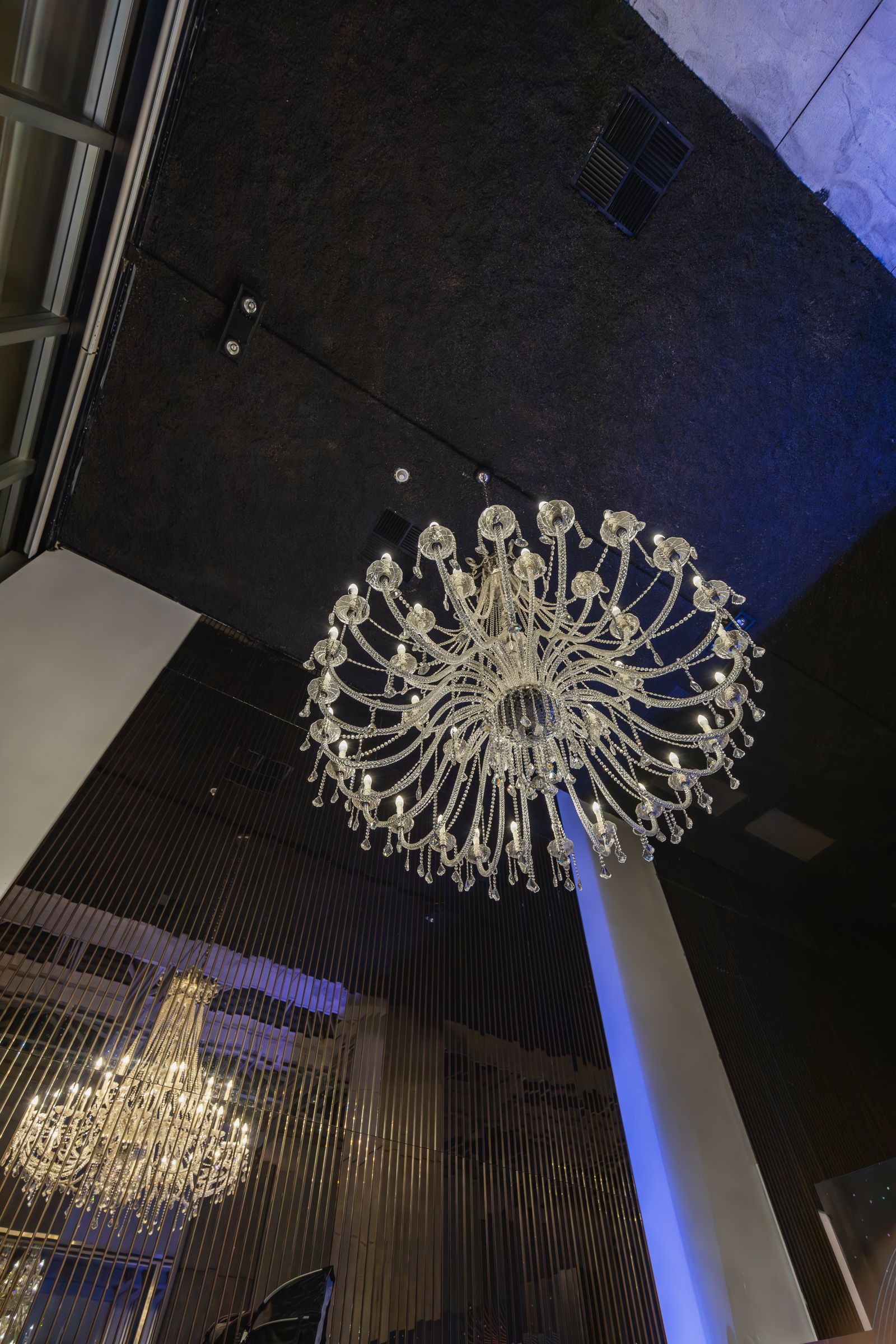 Crystal chandelier installed above a ballroom interior