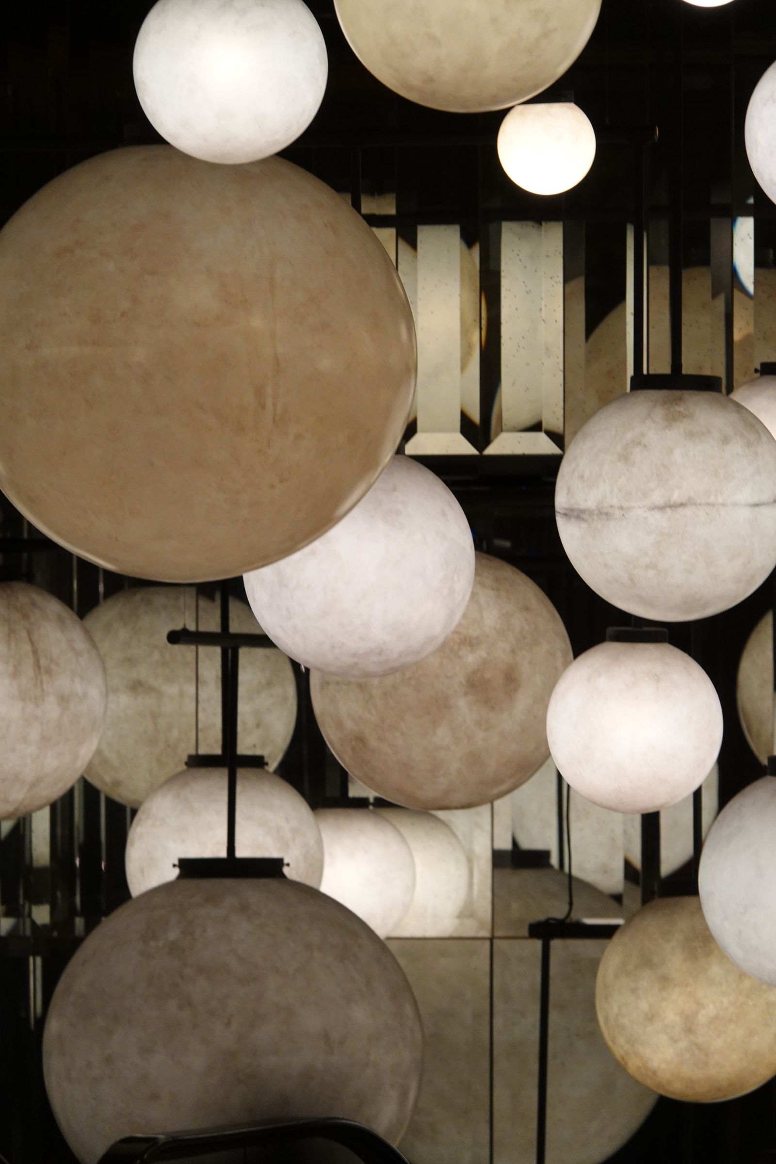 Large spherical chandeliers installed in a tall interior