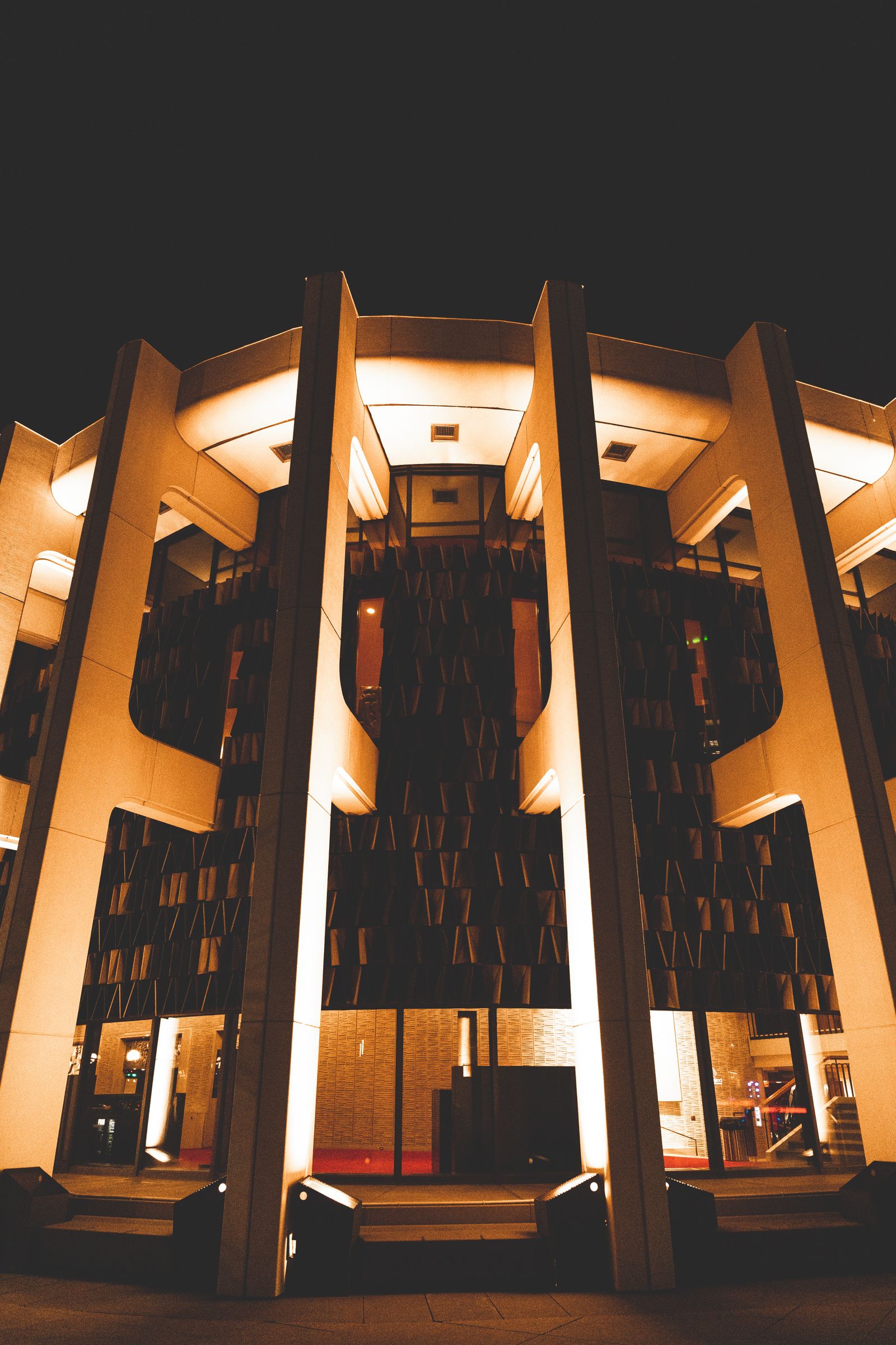 Exterior architectural lighting defining a building facade at night
