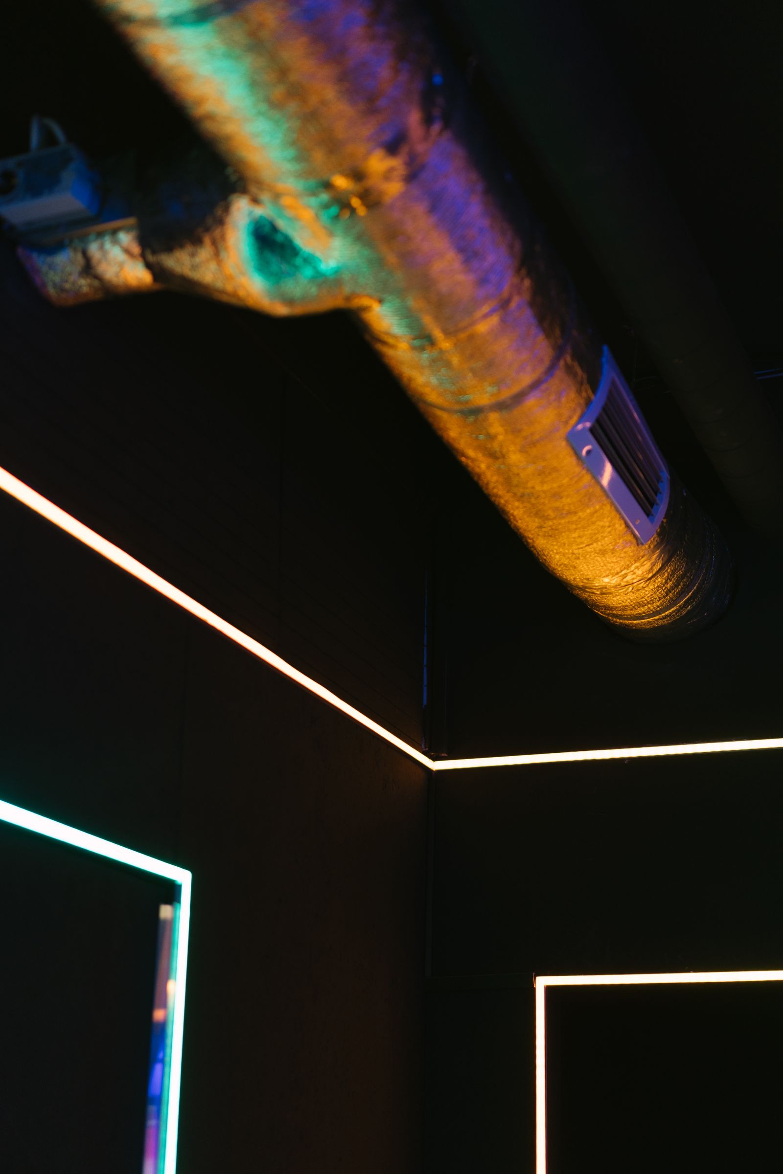 Linear LED lighting installed below exposed ceiling services