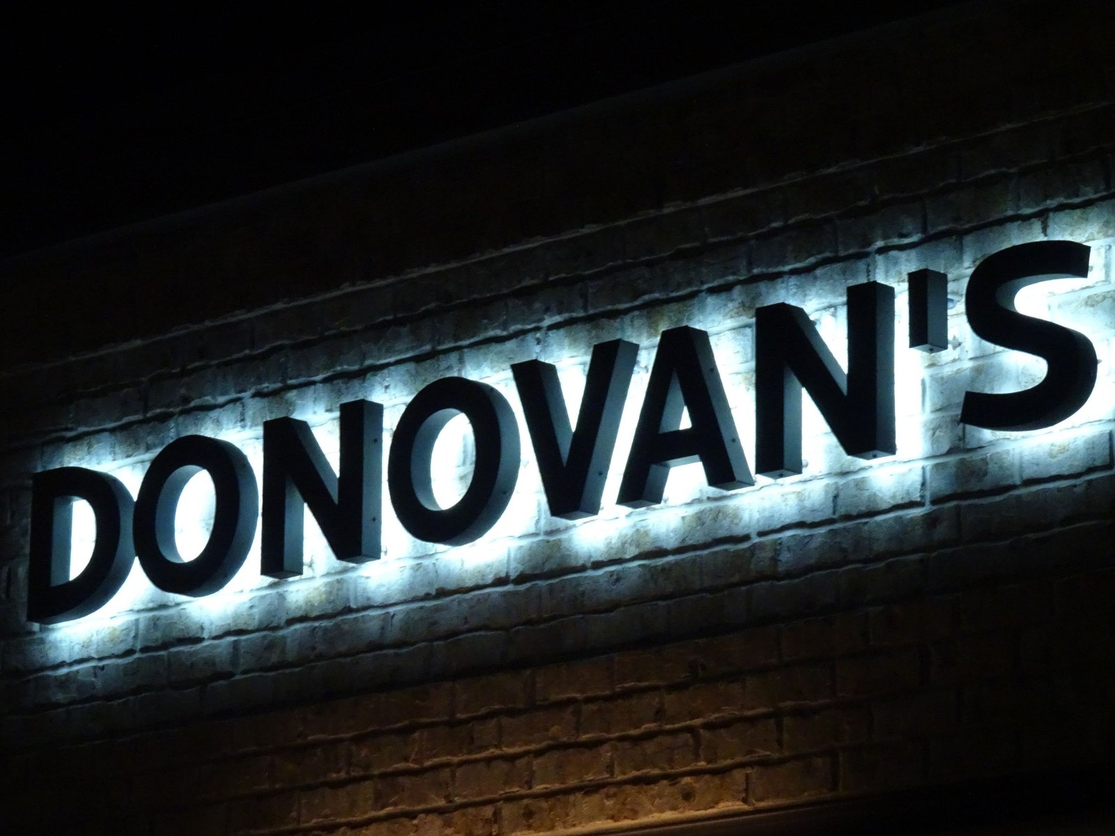 Halo lit reverse channel letters on a dark facade