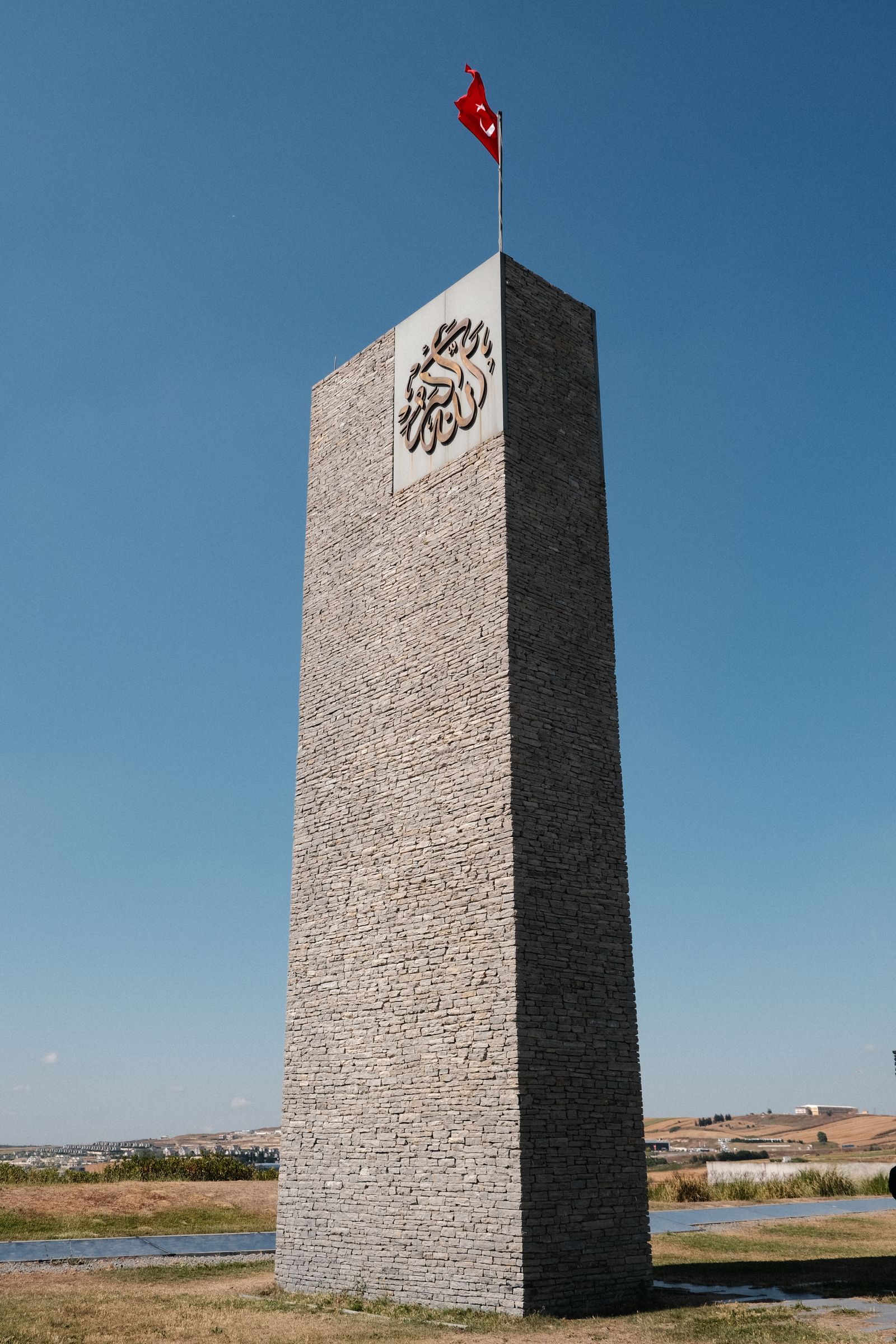 Freestanding stone identification marker viewed against a clear sky