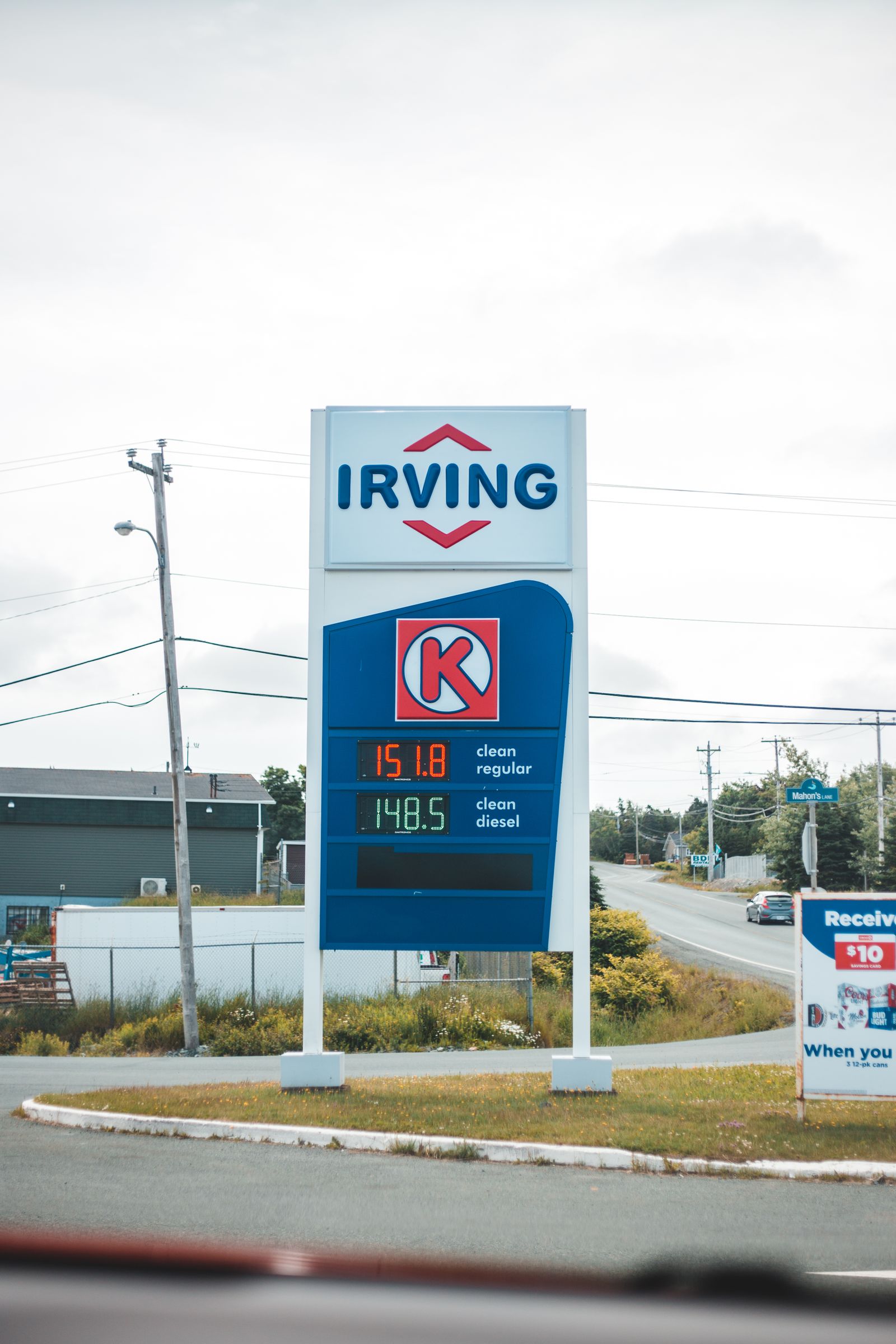Tall roadside commercial identification sign viewed from the street