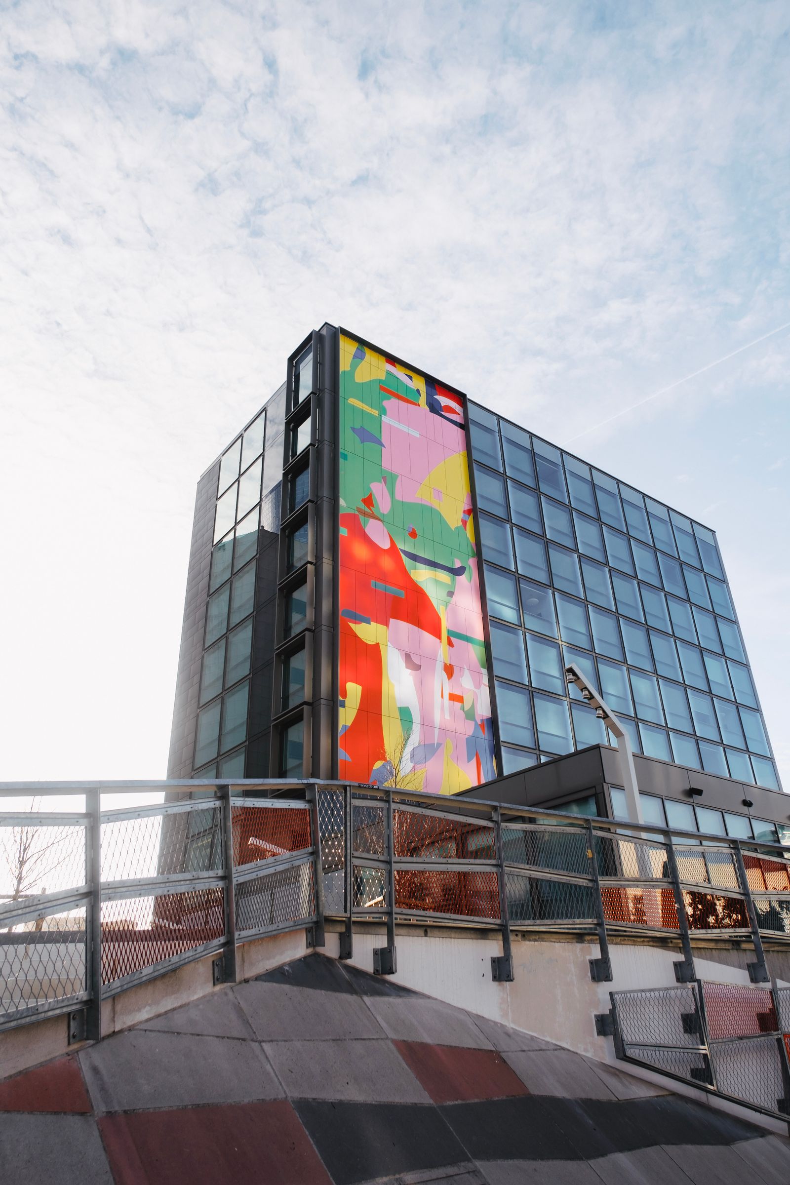 Large colorful graphic applied across an architectural glass wall
